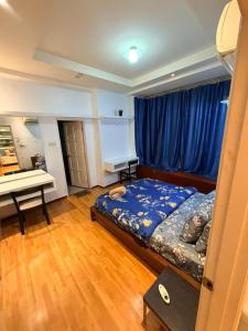 a bedroom with a bed and a desk in it at Klcc Cozy Unit in Kuala Lumpur