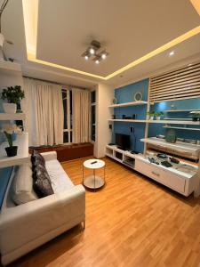 a living room with a couch and a table at Klcc Cozy Unit in Kuala Lumpur