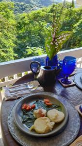 a table with a plate of food on a table at Neita's Nest in Kingston
