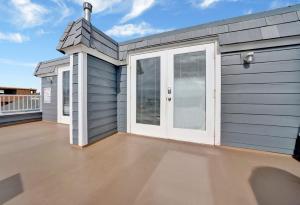 a garage with white doors on a roof at Rooftop Deck with Stunning 360 Beach Views condo in Newport Beach