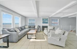 a living room with a couch and two chairs and a table at Rooftop Deck with Stunning 360 Beach Views condo in Newport Beach