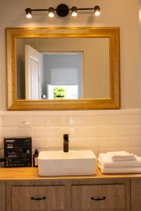 a bathroom with a white sink and a mirror at Casa Cáceres in Lima