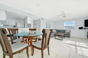 a kitchen and living room with a table and chairs at Ocean and Scenic Beach Views From Deck apts in Newport Beach