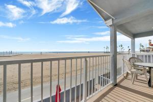 a balcony with a table and chairs and the beach at Ocean and Scenic Beach Views From Deck apts in Newport Beach