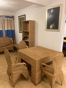 a living room with a table and chairs at Casa Tortuga in Ixtapa