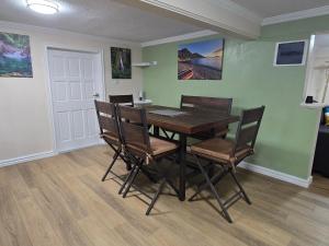 a dining room with a wooden table and chairs at Sunset Haven in Wallhouse