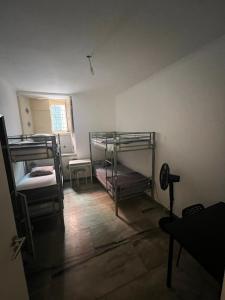 a room with two bunk beds and a window at Varandas do Chiado - Coliving in Lisbon