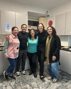 a group of people posing for a picture in a kitchen at Varandas do Chiado - Coliving in Lisbon