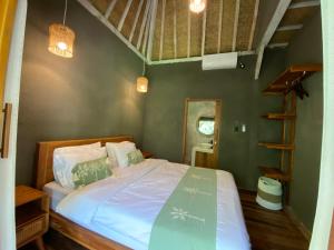 a bedroom with a bed in a room at Seenau House Bali in Selemadeg