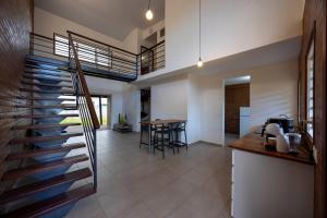a staircase leading to a kitchen and a dining room at Macapa - Destination Guyane in Macouria