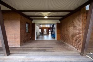 a hallway with a brick wall and a ceiling at Macapa - Destination Guyane in Macouria