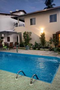 a swimming pool in front of a house at Rancho das mangabeiras in Mata de Sao Joao
