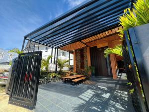 a patio with a wooden table and a fence at Villa Cô Ba 2 in Da Thanh