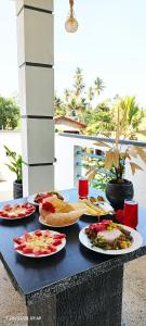 a table with plates of food on top of it at Hiri First In Rest in Dickwella