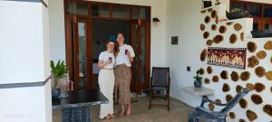 two women standing in front of a door at Hiri First In Rest in Dickwella