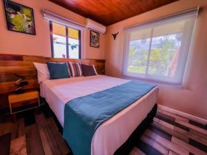 a bedroom with a bed and a window at House Monstera Arenal in Agua Azul +11 photos