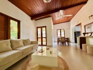 a living room with a couch and a coffee table at Citron Cottage in Kandy