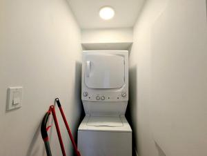 a small room with a tv and a machine at Cozy 1BR Apt perfect for Couple in Longueuil +18 photos