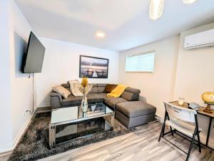 a living room with a couch and a table at Cozy 1BR Apt perfect for Couple in Longueuil
