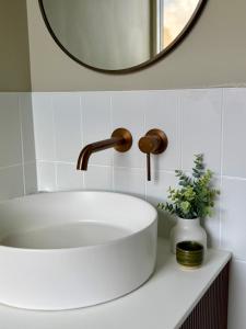 a bathroom sink with a faucet and a mirror at Robertson Public House and Kitchen in Robertson +19 photos