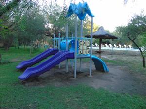 a playground with a slide in a park at Cabañas Mandala in San Marcos Sierras