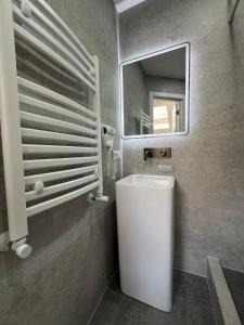 a bathroom with a white sink and a mirror at Bazar Motel in Chişinău