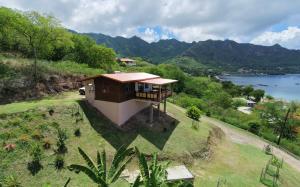 an aerial view of a small house on a hill at Mana Henua Lodge in Nuku Hiva