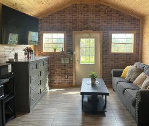 a living room with a couch and a table at Off the Road Oasis in Lufkin