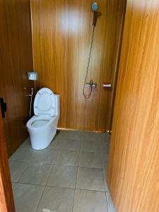 a bathroom with a toilet and a shower stall at Sống Chill Homestay in Nam Yên