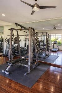 a gym with several tread machines in a room at Arroyos del Paraíso Residencial Suite A in Manuel F. Martínez
