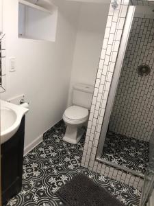 a bathroom with a toilet and a sink and a mirror at Little haven by the woods in Peekskill +22 photos