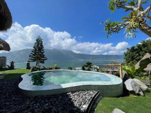 a swimming pool with a view of the water at Santhi Loka in Kubupenlokan +7 photos