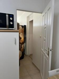 a room with a door and a microwave on a counter at SOLEY City Break 13 in Les Abymes
