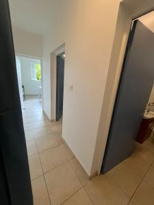 a hallway with a door and a tile floor at SOLEY City Break 13 in Les Abymes