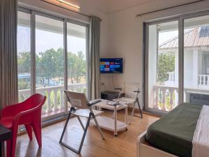 a bedroom with a bed and a table and chairs at NIVANTA-CREAZE by Bendre's in Kārli