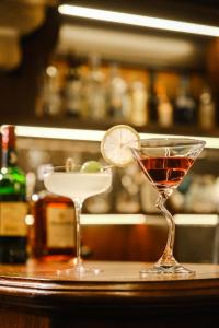 two martini glasses sitting on a bar with a drink at Hui-TEXACO in Gulang Yu