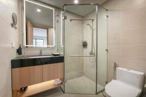 a bathroom with a shower and a toilet and a sink at Hong Ngoc Cochinchine Boutique Hotel & Spa in Hanoi