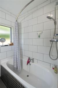 a white tub in a bathroom with a shower at Ocean View in Rosscarbery