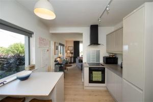 a kitchen with a counter and a living room at Ocean View in Rosscarbery