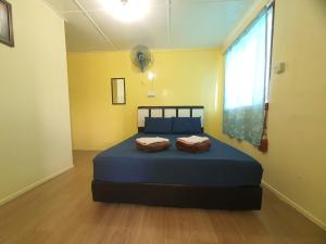a bedroom with a blue bed in a room with a window at D'TERRACE KUNDASANG in Ranau +29 photos