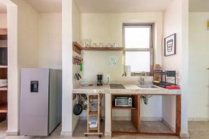 a kitchen with a sink and a refrigerator at Jungle Loft Suite with Terrace & Natural Light - Santuario Hotel Boutique in Chemuyil +66 photos