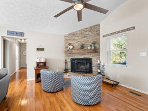 a living room with a fireplace and two chairs at Sunset Cove - Large Cove, Gorgeous Sunsets, Amenities Galore! in Bremen
