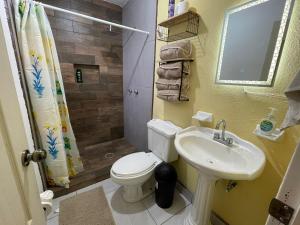 a small bathroom with a toilet and a sink at Your modern getaway with uniquely stylish comfort in Nuevo Casas Grandes