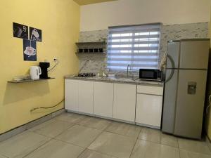 a kitchen with a refrigerator and a sink at Your modern getaway with uniquely stylish comfort in Nuevo Casas Grandes