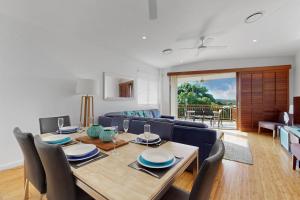 a living room with a table and a blue couch at 6 Colonial in Noosaville