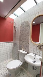 a bathroom with a toilet and a sink at HeHa Ocean Glamping dan Cabin in Ngundel
