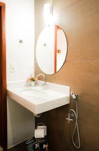 a bathroom with a white sink and a mirror at Pousada do Nonno in Venda Nova do Imigrante +43 photos