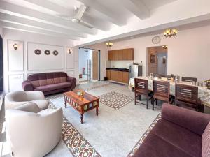 a living room with a couch and a table at NIVANTA-CREAZE by Bendre's in Kārli