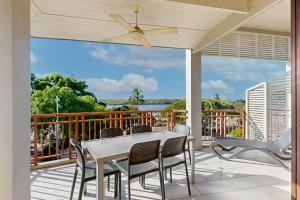 a patio with a table and chairs on a balcony at 6 Colonial in Noosaville