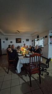 a group of people sitting at a dinner table at Hostal Travesía Urbana in Guadalupe